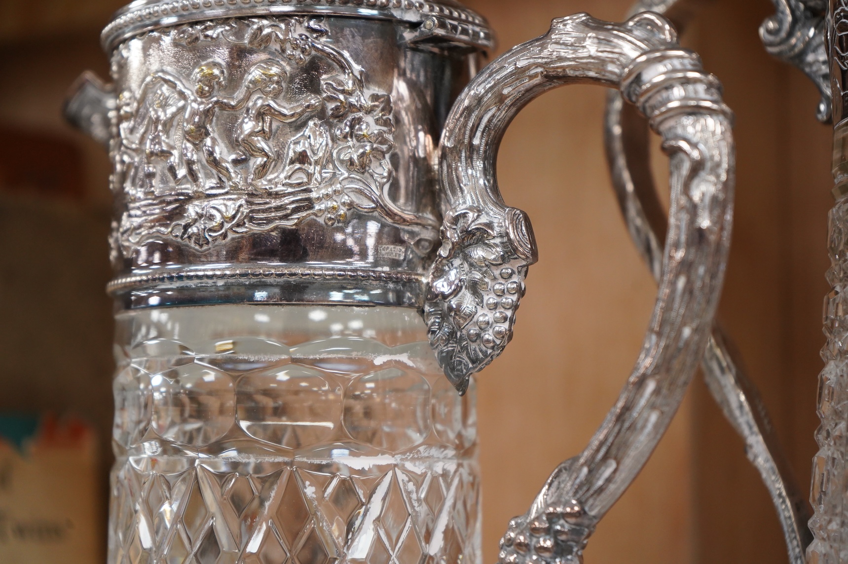 A silver plate mounted glass lemonade jug and a similar claret jug, largest 29cm high